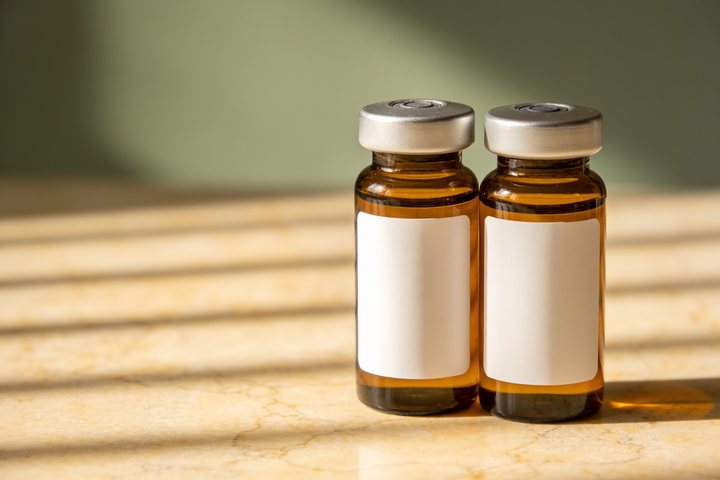 Plain unlabeled laboratory vial on a bare clinical surface, representing a compound Soothe IV does not offer